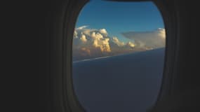 Un ciel nuageux immortalisé depuis le hublot d'un avion (Photo d'illustration).