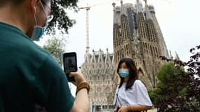 Une jeune femme pose devant la Sagrada Familia le 19 juin 2020