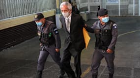 Le président du journal El Periodico José Rubén Zamora escorté par la police le 31 janvier 2023, à Guatemala