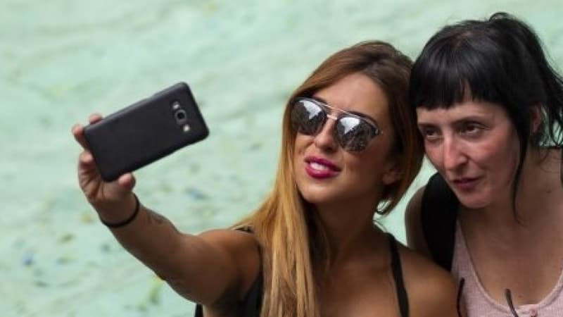 Des touristes prennent un selfie devant la fontaine de Trevi le 14 juillet dernier à Rome en Italie (Photo d'illustration). - Andreas SOLARO / AFP