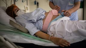 Une infirmière s'occupe d'une femme enceinte à la maternité des Diaconesses à Paris, le 17 novembre 2020