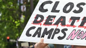 Une manifestante pro-réfugiés à Sydney en 2015, portant une pancarte "fermez les camps de la mort!".