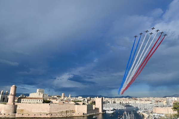 La patrouille française survole le Fort Saint-Jean (à gauche) pour l'arrivée de la flamme olympique au Vieux-Port de Marseille, le 8 mai 2024