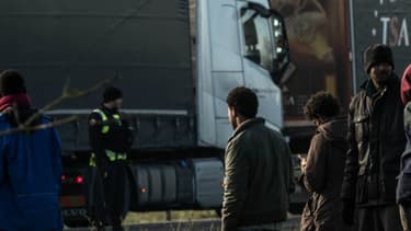 La gendarmerie face à plusieurs migrants sur l'A16 près de Calais, après qu'ils aient tenté de monter à bord de camions le 21 janvier 2016. -