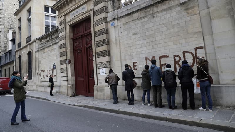 Les mains recouvertes de gants en latex, chacun des militants a dessiné une lettre en capitale sur le mur de pierre