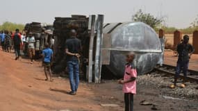 Des habitants de Niamey contemplent le 6 mai 2019 les débits calcinés d'un camion-citerne qui a explosé dans la nuit, faisant au moins 58 morts.