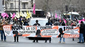 Des manifestants défilent à Paris le 18 février 2023 contre la future loi sur l'immigration portée par Gérald Darmanin