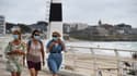 Trois femmes portant des masques de protection se promènent sur le front de mer, le 27 juillet 2020 à Quiberon