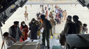 Des Afghans embarquant dans un avion à l'aéroport de Kaboul pour quitter leur pays, mi-août 2021. (PHOTO D'ILLUSTRATION)