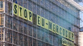 Des militants de l'ONG environnementale Greenpeace accrochent une banderole géante sur le bâtiment du Conseil européen alors qu'ils participent à une manifestation contre l'accord UE-MERCOSUR, à l'extérieur d'une réunion des ministres du Commerce de l'UE à Bruxelles, le 25 mai 2023.