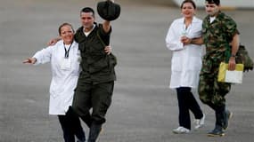 Deux ex-otages des Forces armées révolutionnaires de Colombie soutenus par des soignants à leur arrivée à l'aéroport de Villavicencio, dans le centre de la Colombie, juste après leur libération, lundi. Les guérilleros des Farc ont remis en liberté lundi d