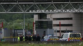 Des policiers se rassemblent sur le site d'une attaque à la voiture bélier qui a eu lieu à un péage routier à Incarville dans l'Eure, dans le nord de la France, le 14 mai 2024.