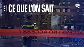 Des pompiers devant l'immeuble ravagé par un incendie, dans le Bronx. 