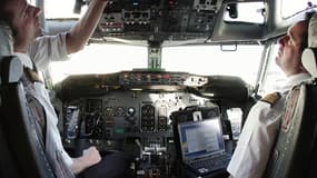 Un pilote prépare son avion pour le décollage, assisté de son copilote.