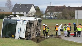 Des pompiers se tiennent à côté d'un bus scolaire accidenté à Jallans, près de Châteaudun, dans le centre de la France, le 30 janvier 2025. 