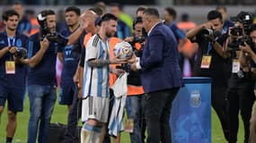 Lionel Messi reçoit le ballon avec lequel il a atteint les 100 buts marqués avec l'Argentine, le 28 mars 2023
