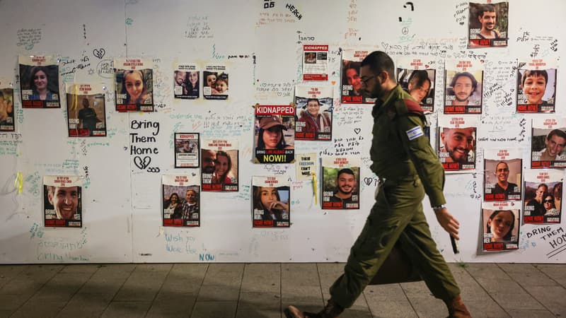 Un soldat israélien passe devant des affiches représentant des otages enlevés par le Hamas, le 22 novembre en 2023, à Tel-Aviv. (Photo d'illustration) 