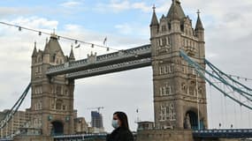 Une femme portant un masque traverse le Tower Bridge à Londres le 1er novembre 2020;