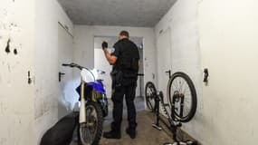 Un policier inspecte une moto dans la cave d'un immeuble dans le cadre d'une opération anti-rodéos urbains, le 11 août 2022 à Nantes