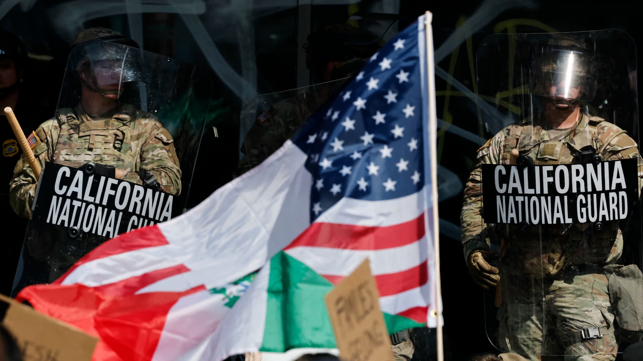 Des manifestants devant des soldats de la Garde nationale de Californie, le 9 juin 2025 à Los Angeles. Des manifestants devant des soldats de la Garde nationale de Californie, le 9 juin 2025 à Los Angeles.