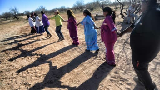 Les Amérindiens de la tribu Tohono O'odham chantent et dansent en invoquant leur totem, l'aigle, contre le mur de Trump qui menace de couper leur territoire en deux, dans le désert d'Altar, le 25 mars 2017