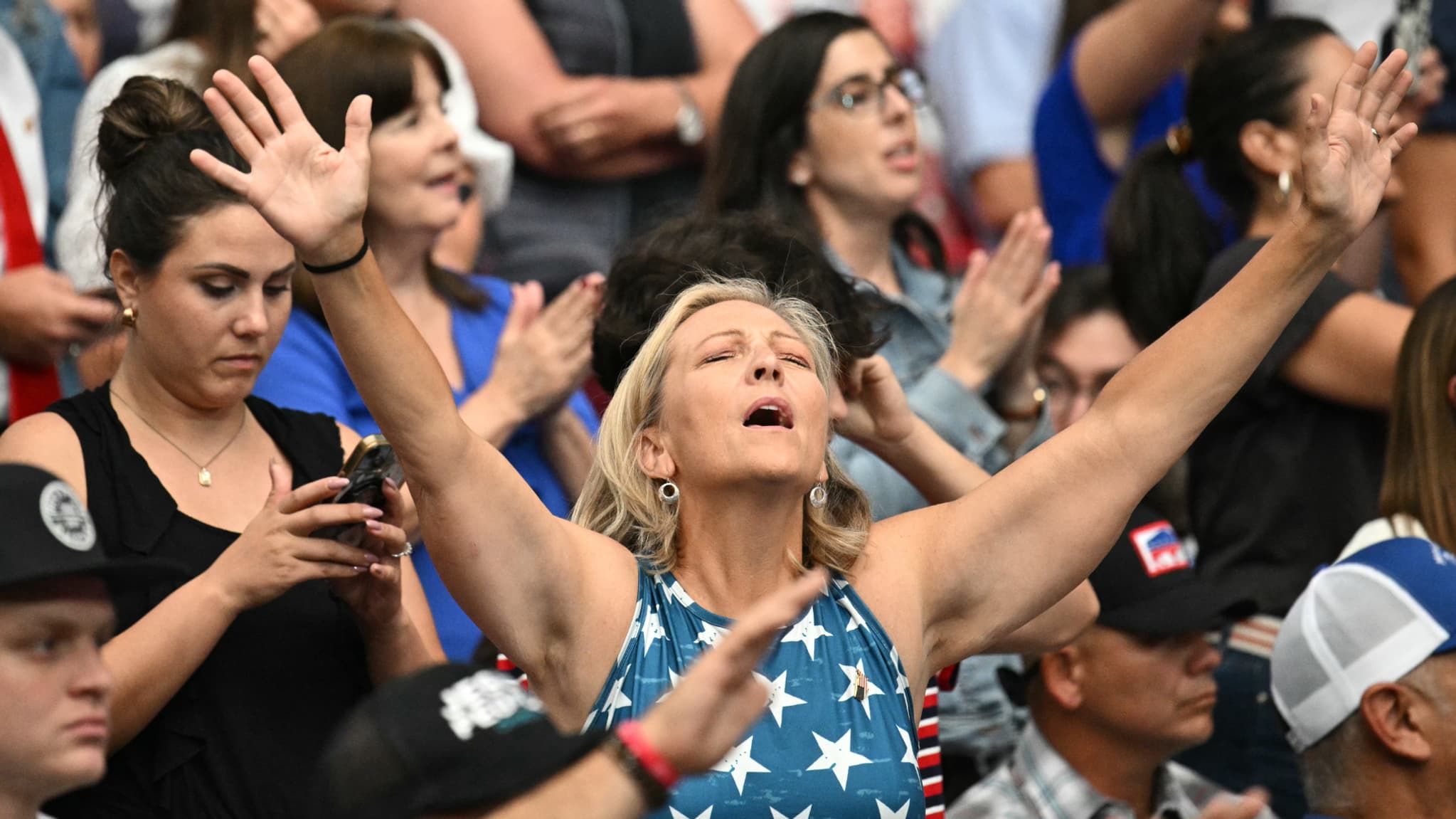 A woman prays during the ceremony in memory of the right activist Charlie Kirk in Glendale, Arizona, September 21, 2025. 