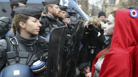 Une artiste déguisée en Marianne fait face aux forces de l'ordre, le 15 décembre 2018 sur les Champs-Elysées à Paris, en marge du rassemblement des gilets jaunes. 