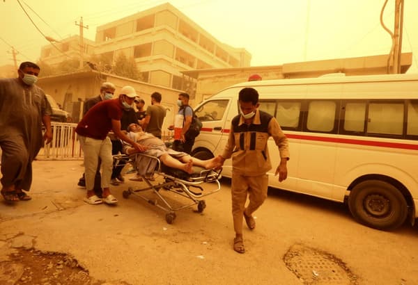 Un patient souffrant de problèmes respiratoires et de suffocation arrive pour être soigné à l'hôpital Sheikh Zayed à Bagdad, la capitale irakienne, le 16 mai 2022, au milieu d'une forte tempête de poussière.
