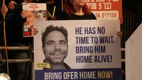 Une manifestation de soutien aux otages du Hamas avec une pancarte montrant l'un d'eux, le Franco-Israélien Ofer Kadelron, à Tel-Aviv, le 30 décembre 2023