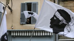 Une femme agite un drapeau corse en marge d'une manifestation pour Yvan Colonna à Bastia le 13 mars 2022.