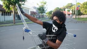 Un résident du quartier de la Valée du Tir à Nouméa observe la barricade dressée par des habitants à Nouméa, en Nouvelle-Calédonie le 16 mai 2024