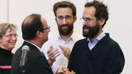 Tanguy et Cyril Moulin-Fournier, entourés de François Hollande