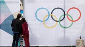 Un couple regarde entre les barrières entourant un site olympique à Paris, le 16 juillet 2024. (Illustration)