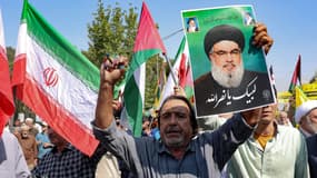 Un Iranien tient un portrait du chef du Hezbollah Hassan Nasrallah, lors d'une manifestation anti-Israël, à Téhéran, le 27 septembre 2024
