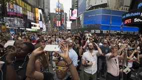 Des centaines de personnes rassemblées à Times Square pour observer l'éclipse totale de soleil, le 21 août 2017 à New York. 
