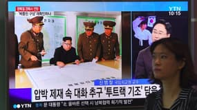 Une femme passe devant un écran montrant le leader nord-coréen Kim Jong-Un. Photo prise à Séoul le 15 août 2017