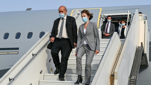 Le chef de la diplomatie française Jean-Yves Le Drian (G) la ministre des Armées Florence Parly arrivent à la base 104 d'Al Dhafra, près d'Abou Dhabi le 23 août 2021