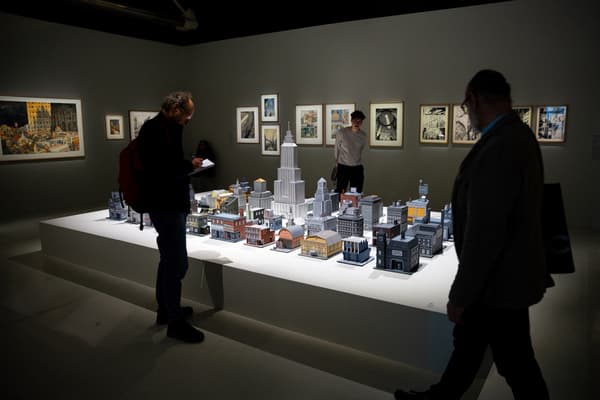 Visitors discovering designer Seth's model at the'“Comics (1964-2024)” exhibition at the Pompidou Center”></source></picture></noscript><figcaption><span class= Visitors discovering designer Seth's model in the'