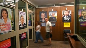 Des électeurs français passent devant les affiches des candidats à la présidence française; au consulat de France à Mumbai, le 10 avril 2022.