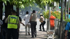 Des policiers indonésiens devant un café après une série d'explosions dans le centre de Jakarta, le 14 janvier 2016