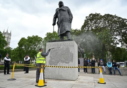 La statue de l'ancien Premier ministre britannique Winston Churchill est nettoyée pour ôter un graffiti selon lequel il "était un raciste", près du Parlement à Londres le 8 juin 2020 La statue de l'ancien Premier ministre britannique Winston Churchill est nettoyée pour ôter un graffiti selon lequel il "était un raciste", près du Parlement à Londres le 8 juin 2020