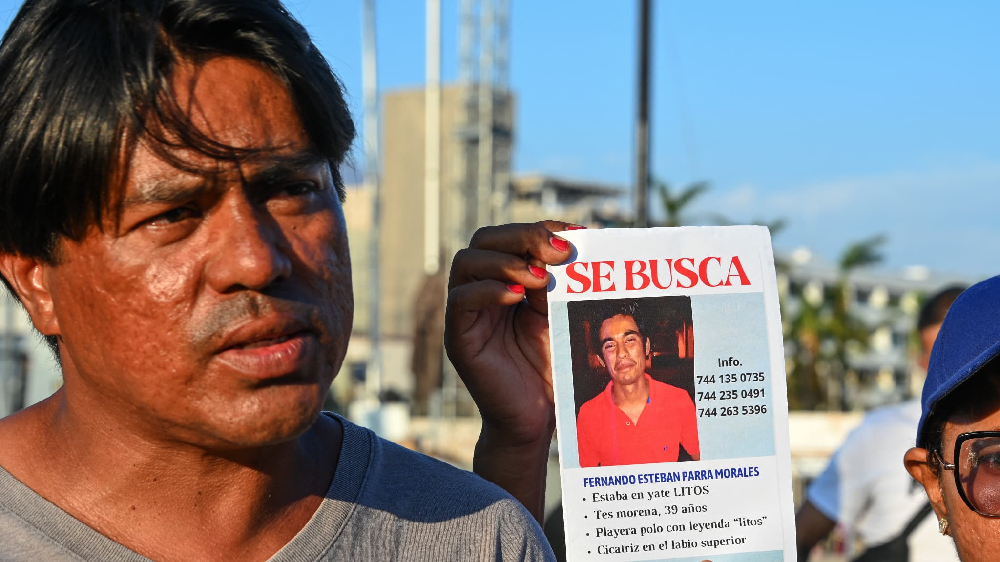 Saul Parra montre une photo de son frère disparu à bord d'un bateau endommagé après le passage de l'ouragan Otis à Acapulco, État de Guerrero, Mexique, le 5 novembre 2023. 