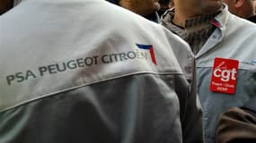 Employés de PSA Peugeot Citroën devant le siège du groupe à Paris, mardi. Le constructeur automobile va supprimer 5.000 emplois en France dans le cadre de son plan européen de réductions de coûts annoncé pour 2012, selon la CGT. /Photo prise le 15 novembr