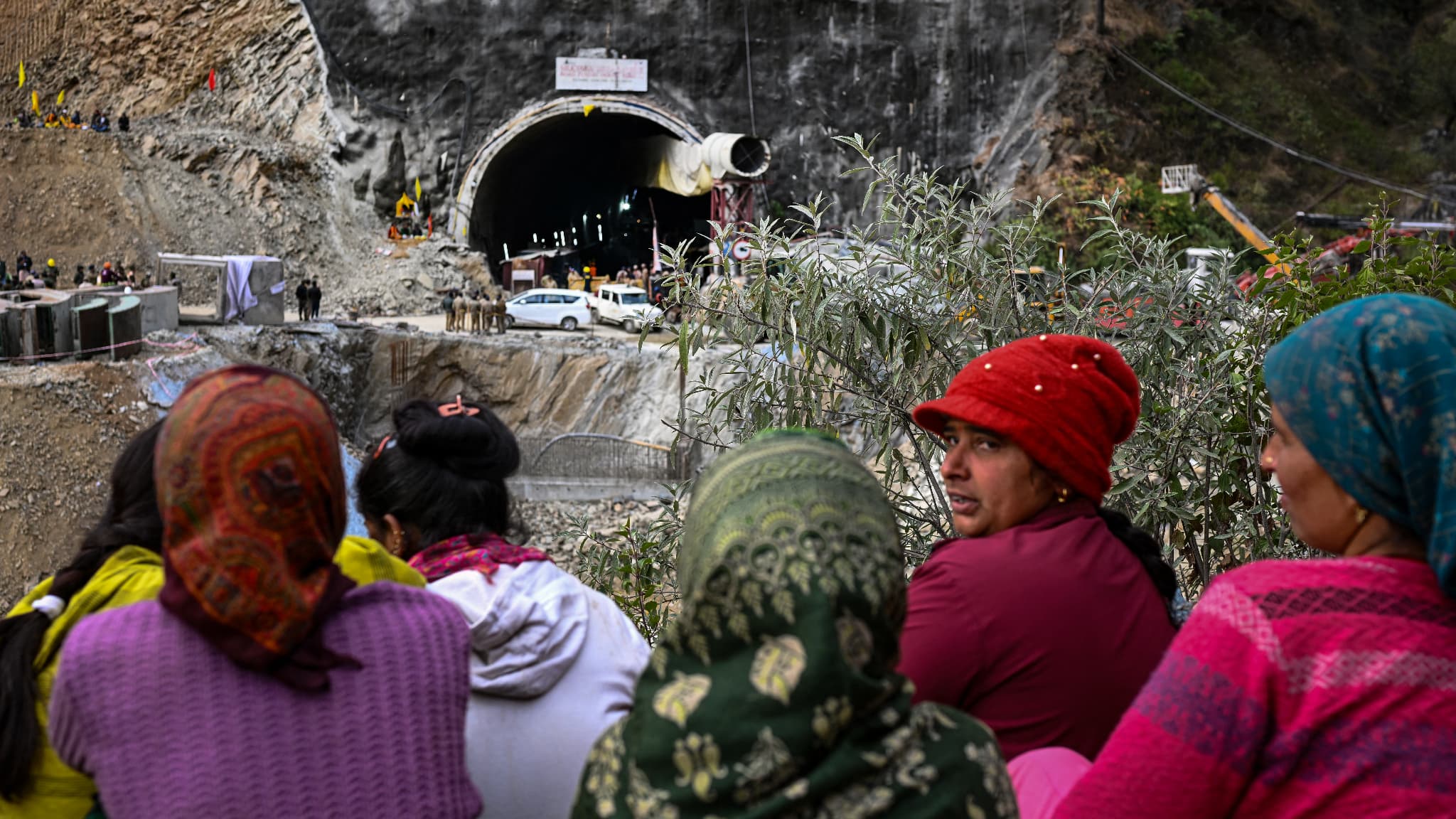 Des villageois et des habitants se rassemblent pour observer les efforts déployés par les secouristes pour sauver les 41 hommes coincés dans le tunnel Silkyara en construction qui s'est effondré dans le district d'Uttarkashi, dans l'État indien de l'Uttarakhand, le 28 novembre 2023. 