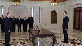 Le président syrien Bachar al Assad (à droite) face à son nouveau Premier ministre Adel Safar. Bachar al Assad a annoncé la promulgation d'ici la semaine prochaine "au plus tard" d'un texte de loi levant l'état d'urgence en vigueur en Syrie depuis 48 ans.
