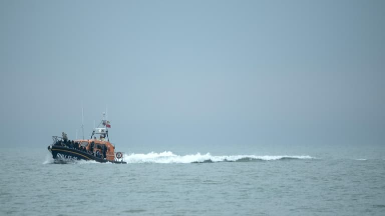 Un bateau britannique approche d'une plage anglaise après avoir secouru des migrants qui tentaient de traverser la Manche, le 24 novembre 2021