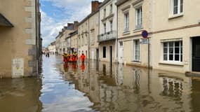 Des sauveteurs interviennent dans une rue inondée à Craon, en Mayenne, le 20 juin 2024. 