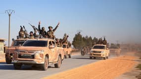 Des combattants anti-gouvernementaux conduisent des véhicules militaires sur une route dans la partie orientale de la province d'Alep, le 1er décembre 2024.
