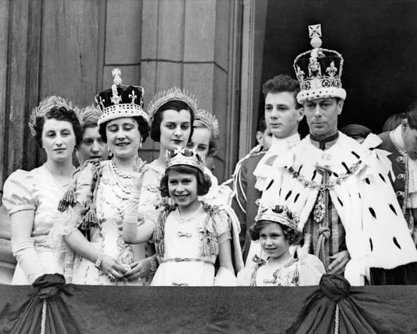 Young Elizabeth, future Queen Elizabeth II, with her father King George VI on the balcony in Buckingham.