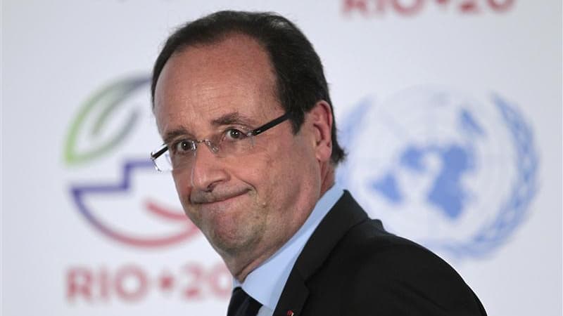 Selon la porte-parole du gouvernement, un officier de sécurité a oublié les armes destinées à protéger François Hollande lors de sa récente visite à Rio, mais le président a toujours eu d'autres officiers armés à sa disposition. /Photo prise le 20 juin 20